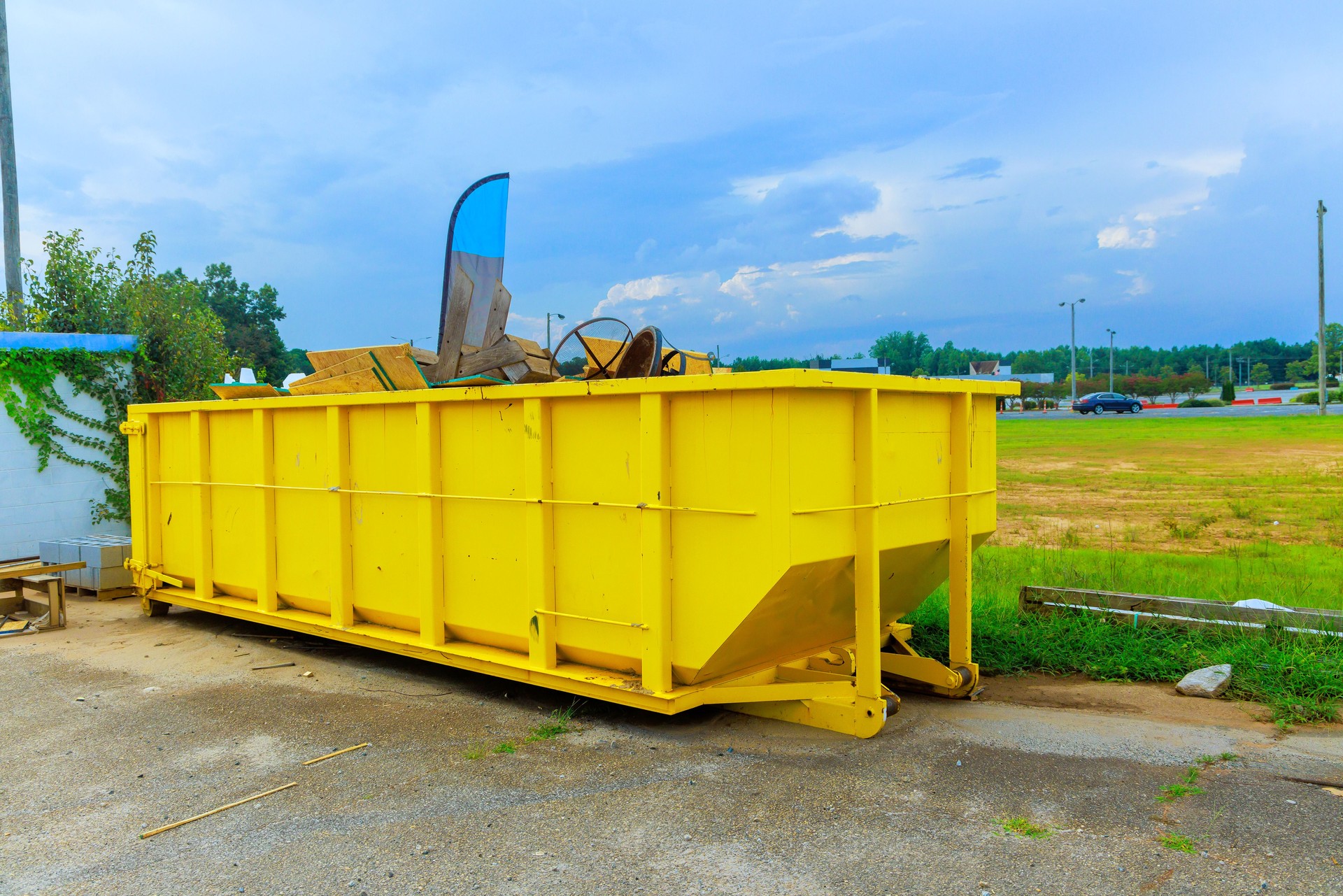 Construction site dumpsters of metal containers for a collection of waste during construction